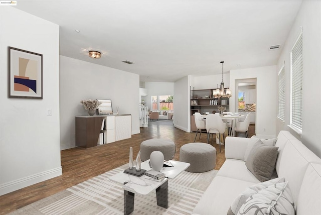 living room featuring a notable chandelier and hardwood / wood-style floors