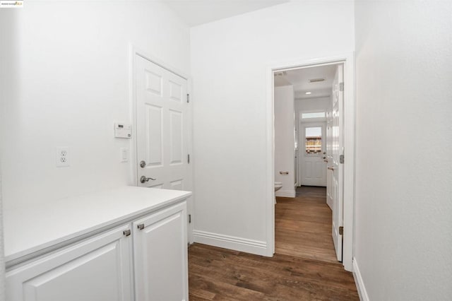 corridor featuring dark wood-type flooring