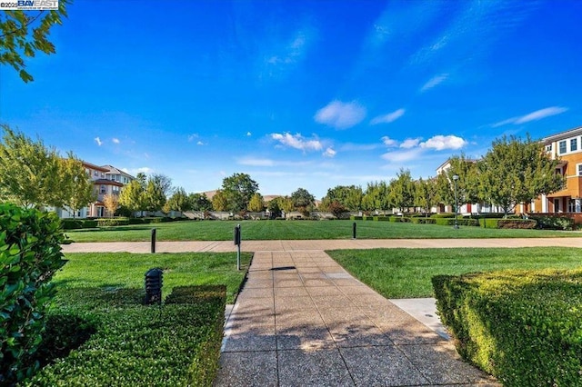 view of home's community featuring a lawn