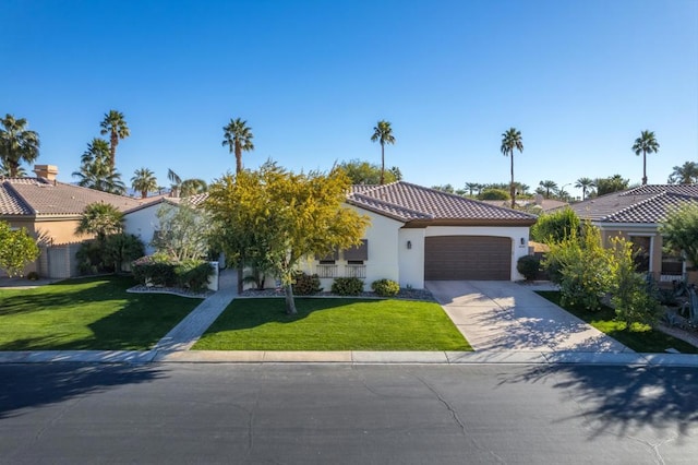 mediterranean / spanish-style house with a garage and a front yard