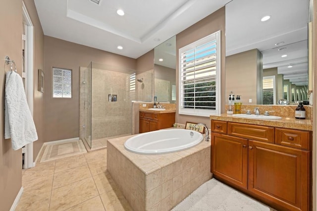 bathroom featuring tile patterned floors, vanity, and shower with separate bathtub