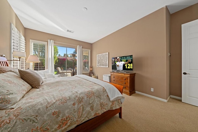 carpeted bedroom featuring access to exterior