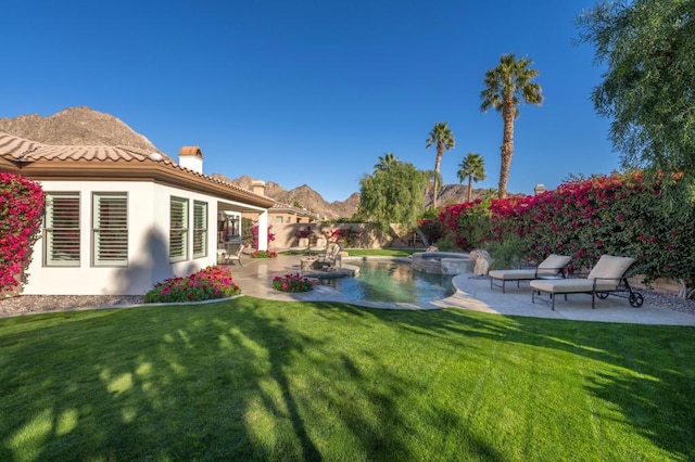 view of yard with a pool with hot tub and a patio