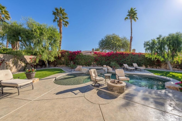 view of swimming pool featuring a patio area, an outdoor fire pit, and an in ground hot tub