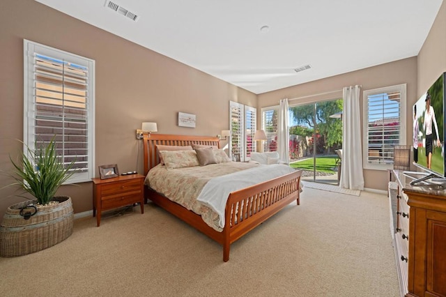 bedroom featuring access to outside and light colored carpet