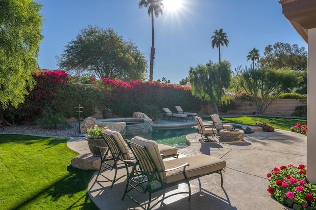 view of patio with a pool with hot tub and an outdoor fire pit