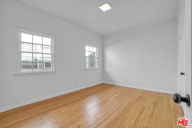 unfurnished room with a healthy amount of sunlight and light wood-type flooring