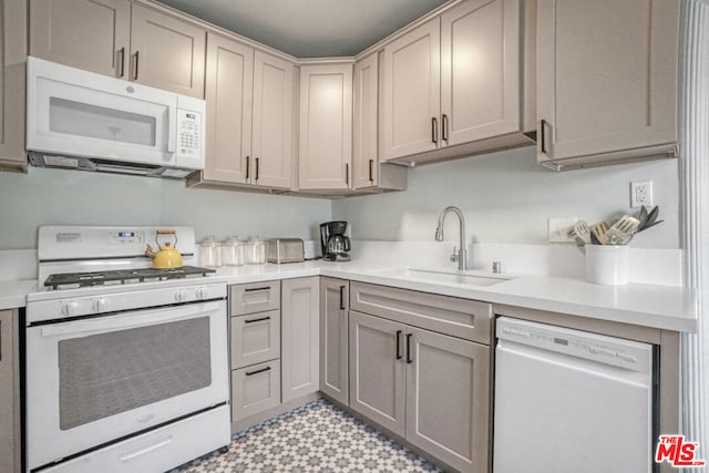 kitchen featuring sink and white appliances