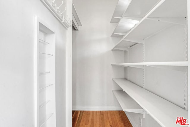 walk in closet featuring wood-type flooring