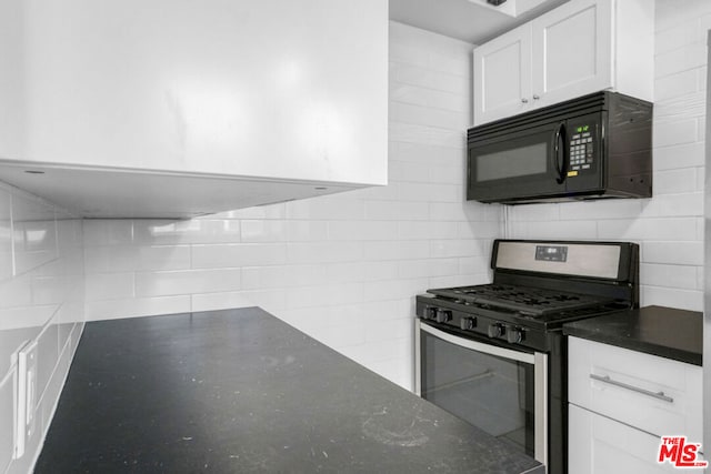 kitchen featuring stainless steel gas range oven and white cabinetry