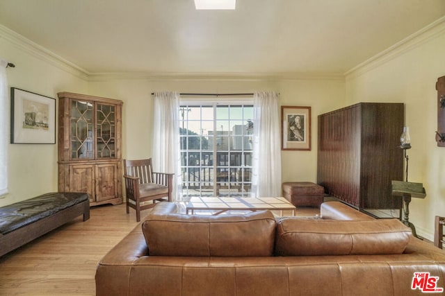 living room featuring light hardwood / wood-style flooring and ornamental molding