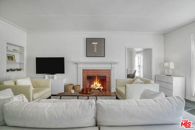 living room with built in features, a brick fireplace, and ornamental molding