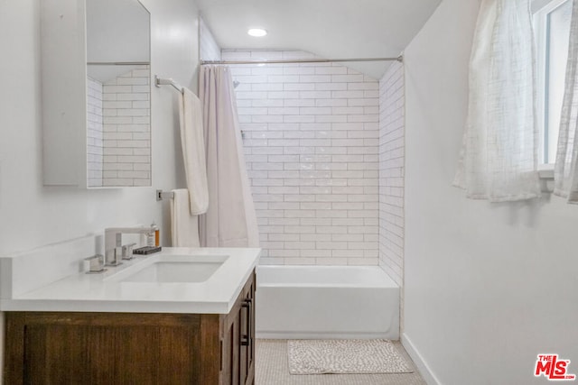 bathroom with tile patterned flooring, vanity, and shower / tub combo with curtain