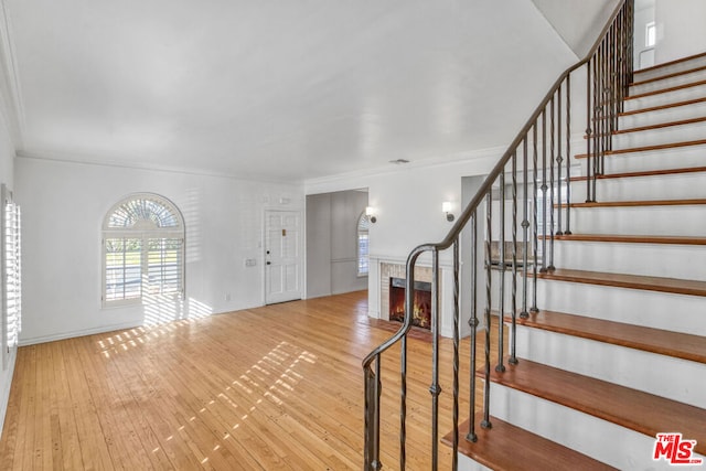 entrance foyer featuring light hardwood / wood-style floors and ornamental molding