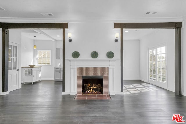 unfurnished living room featuring a wealth of natural light, ornamental molding, and a fireplace