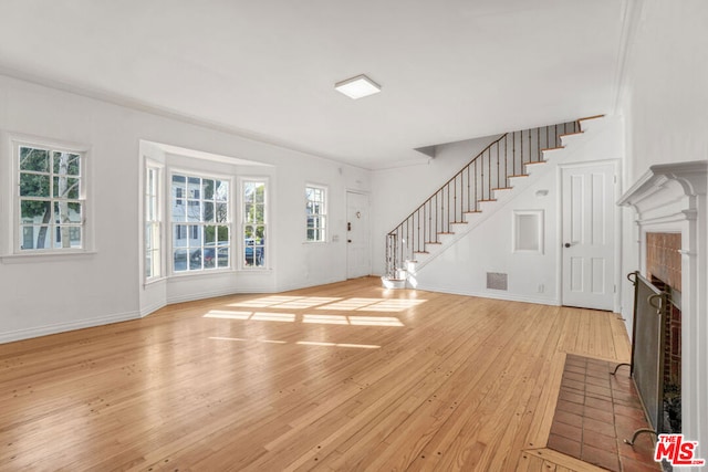 entryway with light wood-type flooring and ornamental molding