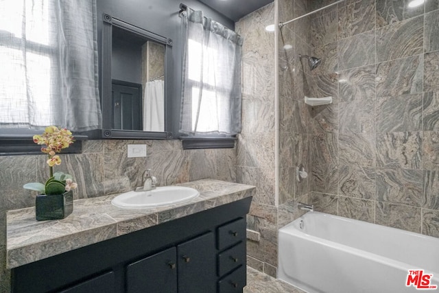 bathroom featuring decorative backsplash, shower / tub combo, and vanity