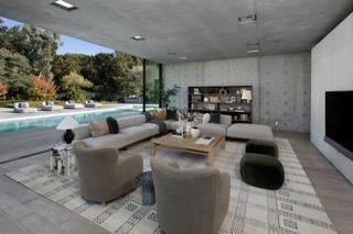 living room featuring a wealth of natural light and a wall of windows