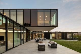 rear view of house featuring a lawn, outdoor lounge area, and a patio