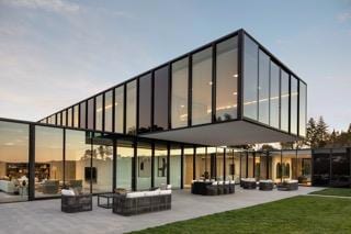 back house at dusk featuring an outdoor living space and a patio area