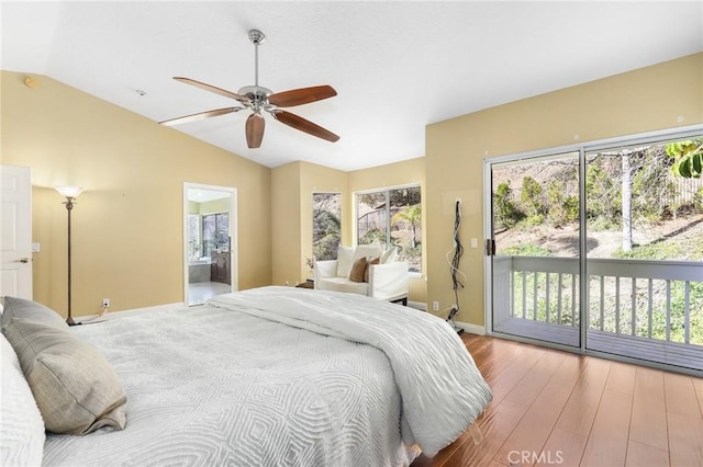 bedroom with vaulted ceiling, connected bathroom, wood-type flooring, access to outside, and ceiling fan