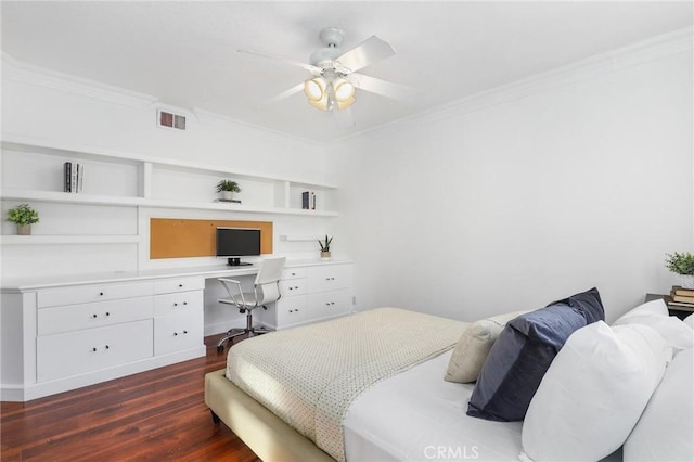 bedroom with built in desk, ornamental molding, dark hardwood / wood-style floors, and ceiling fan