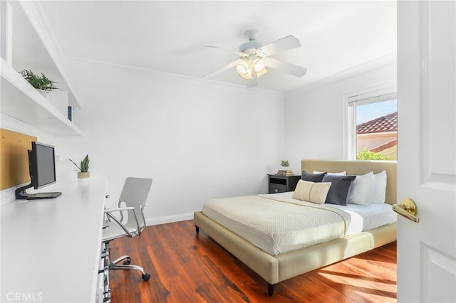 bedroom with dark wood-type flooring, ornamental molding, and ceiling fan