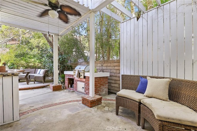 view of patio with area for grilling, grilling area, a pergola, ceiling fan, and an outdoor hangout area