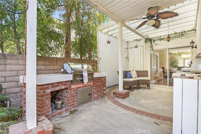 view of patio featuring area for grilling, ceiling fan, and an outdoor kitchen