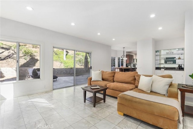 living room with plenty of natural light and a chandelier