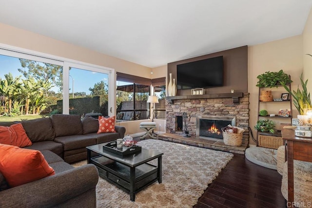 living room with a fireplace and wood finished floors