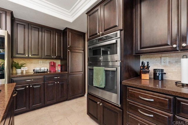 kitchen with double oven, dark stone countertops, and dark brown cabinets