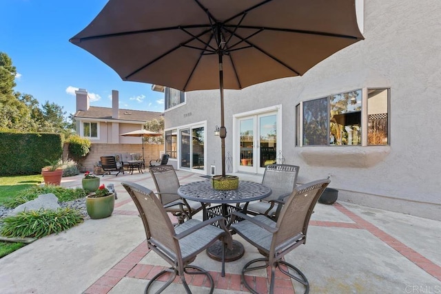 view of patio featuring outdoor dining area and fence