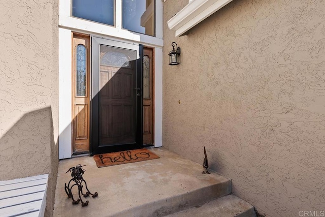 doorway to property with stucco siding