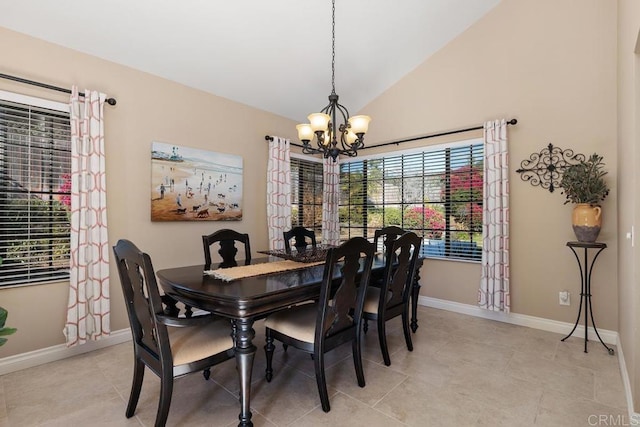 dining space featuring lofted ceiling, light tile patterned floors, a chandelier, and baseboards