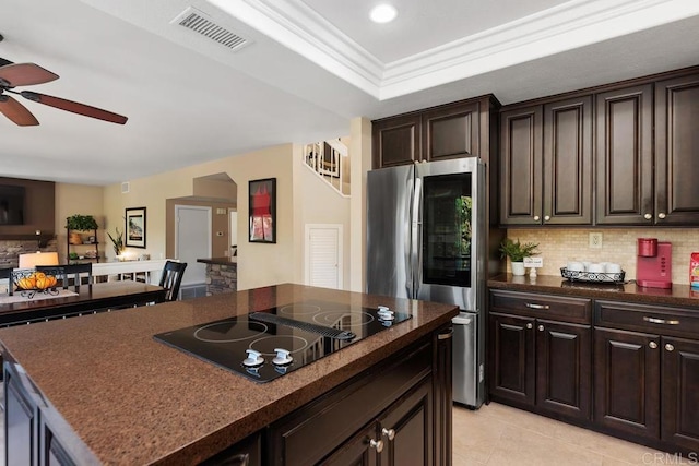 kitchen featuring black electric stovetop, dark countertops, visible vents, smart refrigerator, and a kitchen island