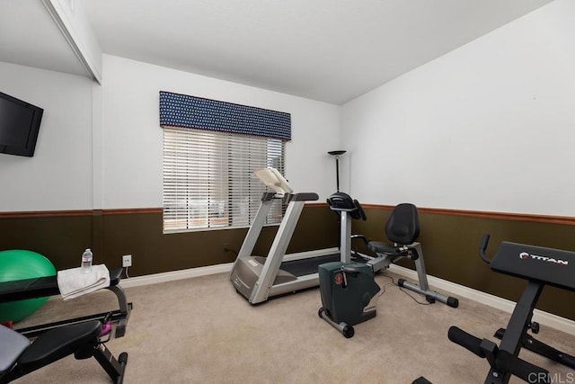 workout room with light carpet and baseboards