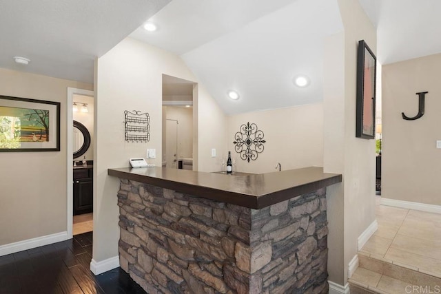 bar featuring lofted ceiling, wood finished floors, baseboards, and recessed lighting