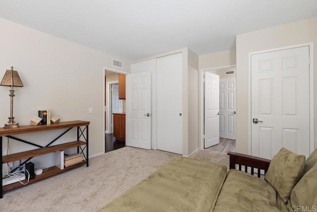 bedroom with carpet floors, a closet, visible vents, and baseboards