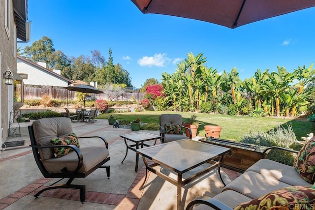 view of patio featuring outdoor dining area and fence