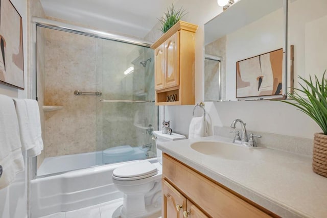 full bathroom featuring tile patterned floors, vanity, toilet, and combined bath / shower with glass door