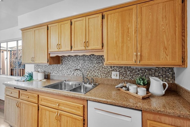 kitchen with white dishwasher, sink, backsplash, and light stone countertops