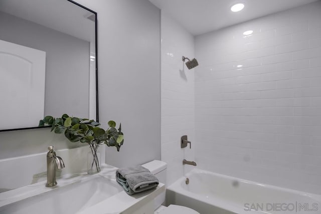 full bathroom featuring washtub / shower combination, sink, and toilet