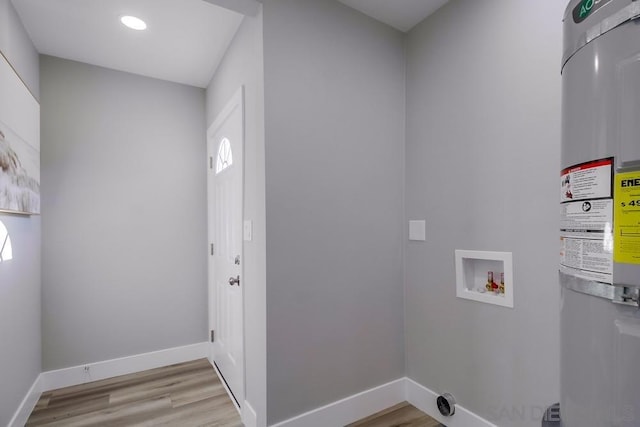 laundry area with hookup for a washing machine, light hardwood / wood-style flooring, water heater, and hookup for an electric dryer