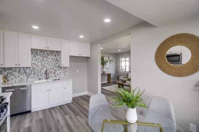 kitchen with sink, stainless steel appliances, and white cabinetry