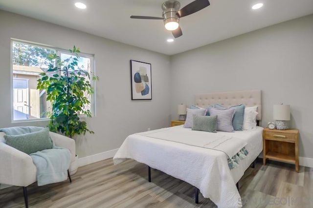 bedroom with hardwood / wood-style floors and ceiling fan