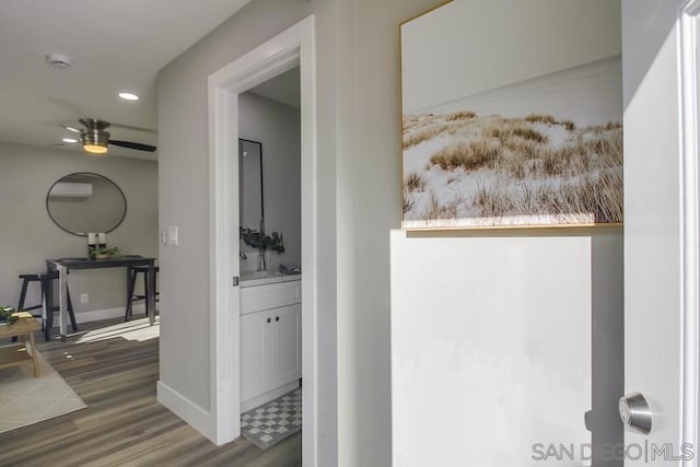 hallway featuring sink and dark wood-type flooring