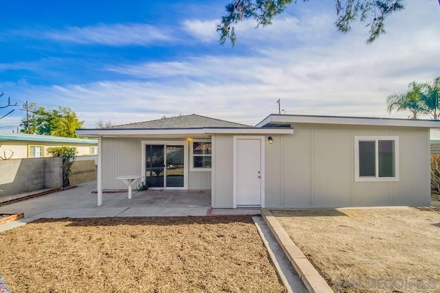 back of property with a patio