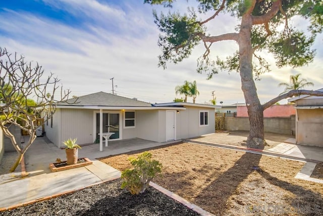 rear view of property featuring a patio area