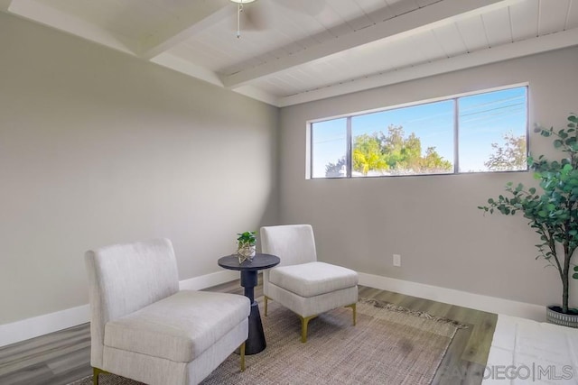 living area with hardwood / wood-style flooring and beamed ceiling